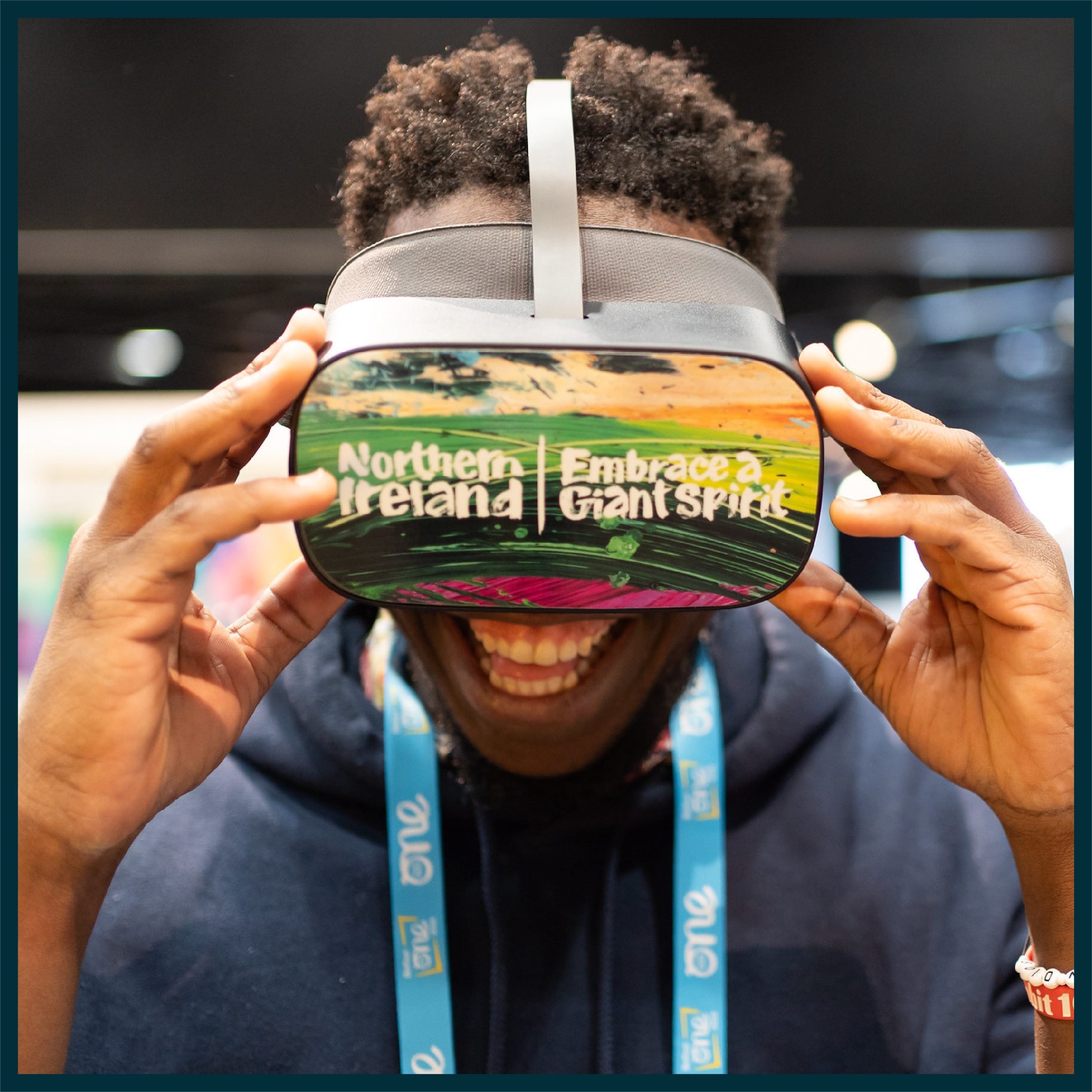 Image of Delegate at One Young World 2023 Summit wearing VR headset reading 'Northern Ireland: Embracing Giant Spirit'