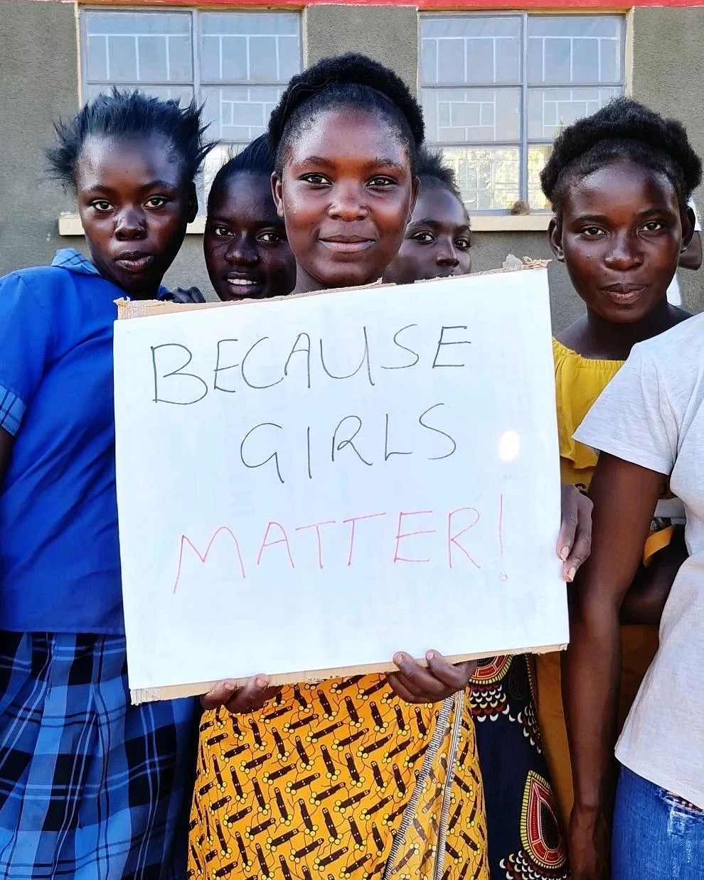 a group of girls standing with the poster saying girls matter 