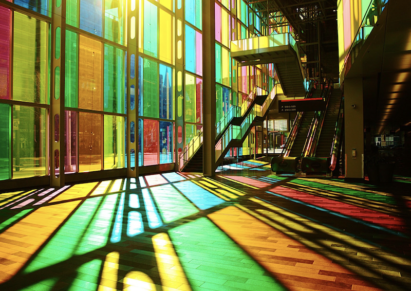 Montréal Convention Centre (Le Palais des congrès de Montréal) photo taken inside with sunlight streaming through colourful stained glass windows