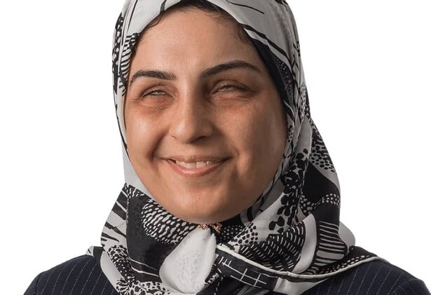 Portrait of Fadeia in white and black patterned headscarf