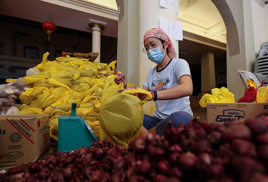 Refuge for the Refugees staff packing groceries