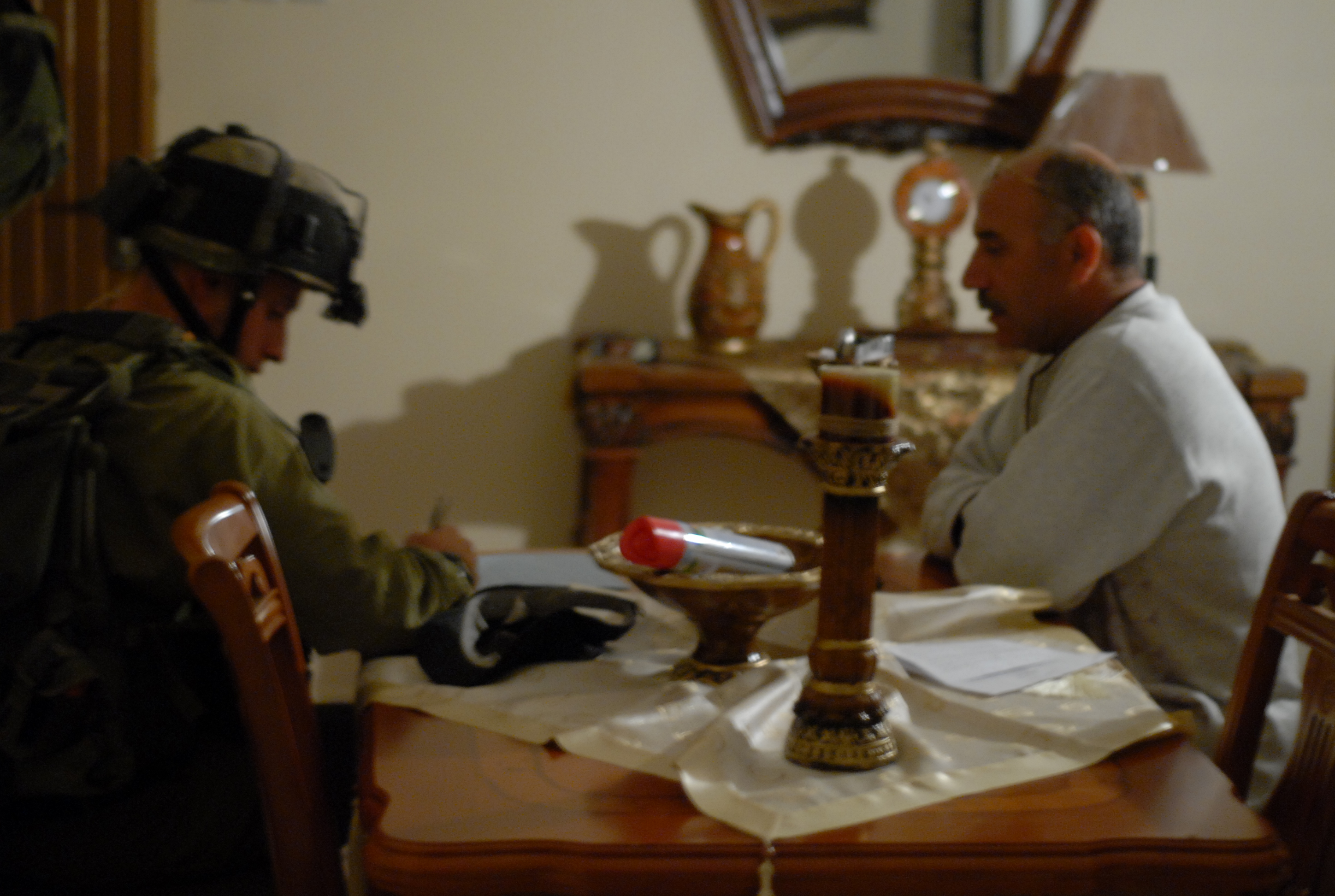 Image: Soldier sitting in Palestinian home