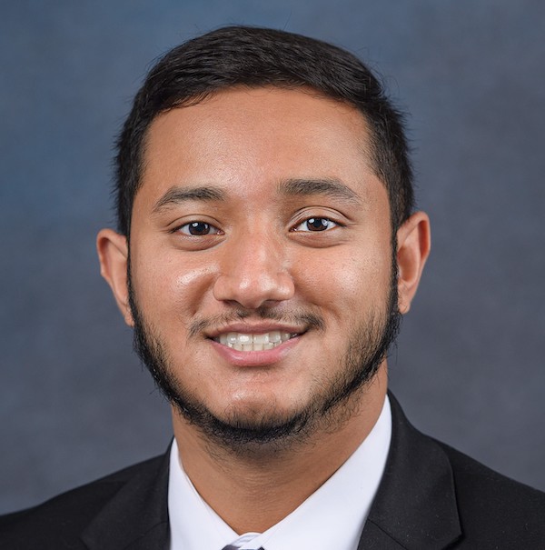 Nazbi Chowdhury headshot in suit and tie