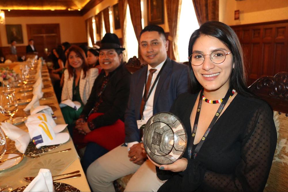 Ecuador delegation National Prizes Winners- female young leader holding award