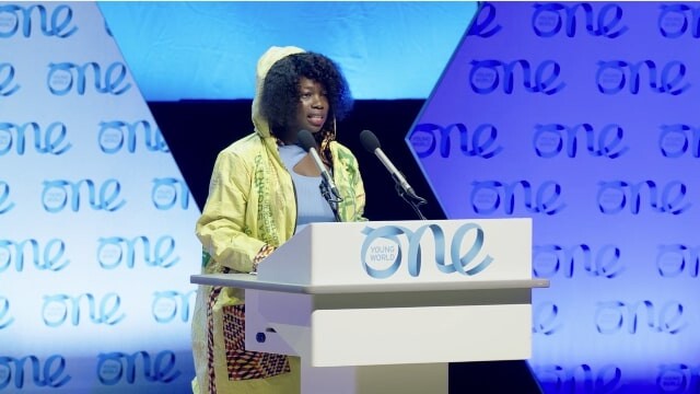 Juliet Namujju on stage presenting at the Climate Emergency Plenary, Belfast Summit 2023