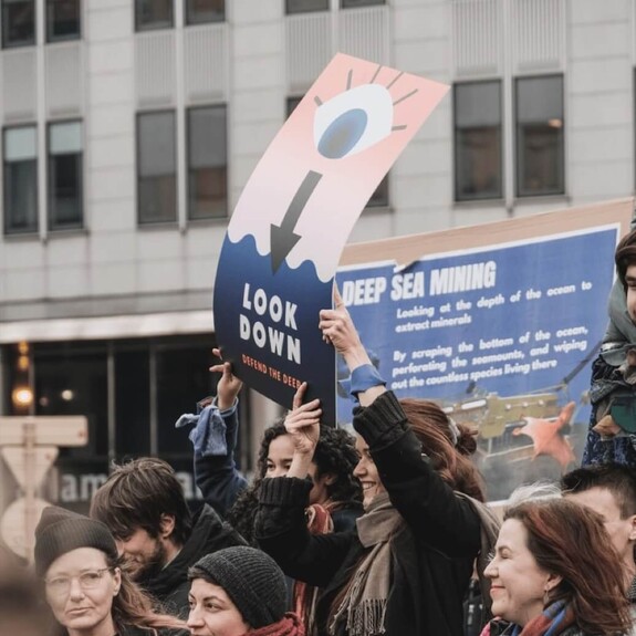 Protesters with placards about deep sea mining