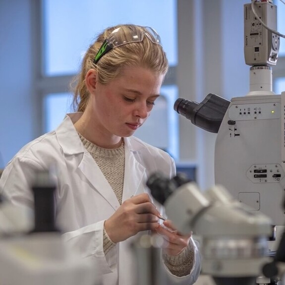 Imogen Napper in white lab coat in scientific laboratory