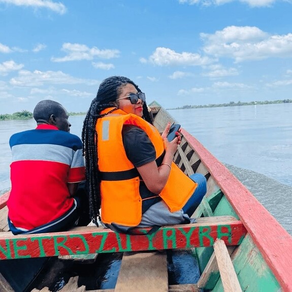 Two people travelling in small fishing boat