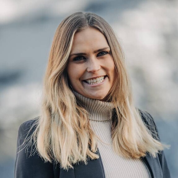 Portrait of Livia Altmann in white turtleneck top and grey blazer