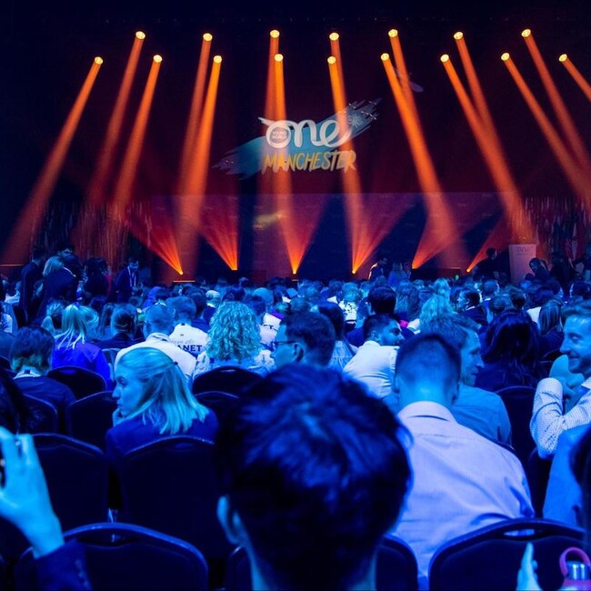 Presentation Stage with audience waiting under blue light, Manchester Summit 2022