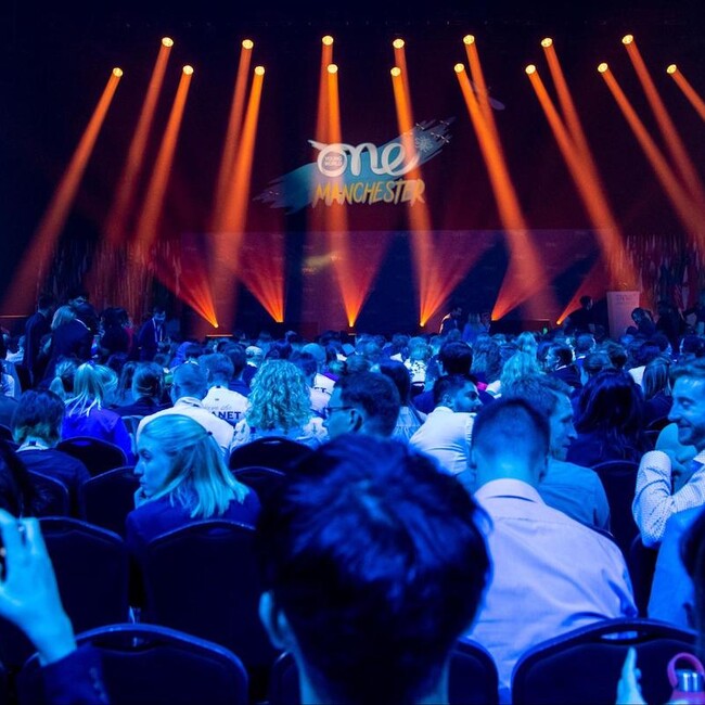 Presentation Stage with audience waiting under blue light, Manchester Summit 2022