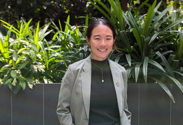 Samantha Thian in business attire, against lush green background