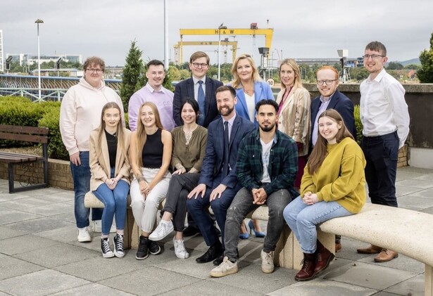 SEUPB Program Group photo of delegates in Belfast in front of Samson and Goliath cranes in the distance