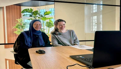 Giselle and Olena, another EqualReach team member, sit smiling
