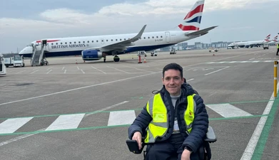 Joshua Wintersgill in front of an airplane