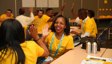 Young leaders smiling and giving each other a high-five