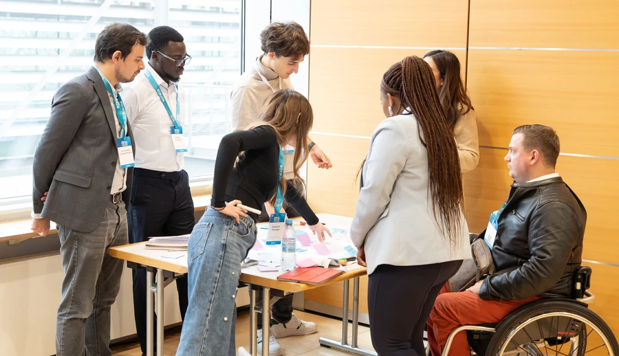 People standing around a table discussing