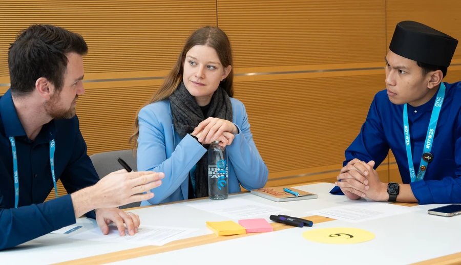 three people talking, 2 male and a female