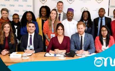 meghan and harry at a table with 13 one young world ambassadors 