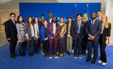 EUVP Ambassadors and One Young World staff smile for a picture at the European Commission Building in Brussels, Belgium