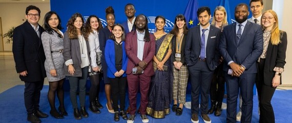 EUVP Ambassadors and One Young World staff smile for a picture at the European Commission Building in Brussels, Belgium