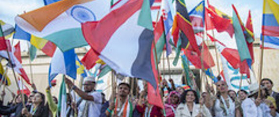 Flagbearers waving national flags at OYW summit