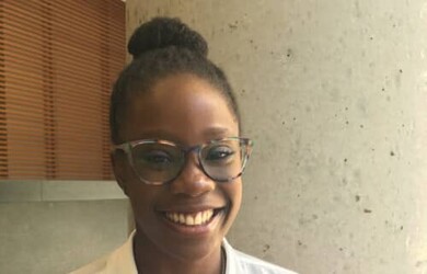 Cyrielle portrait wearing white shirt and glasses