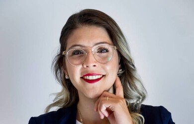 Laura portrait wearing formal attire against grey background