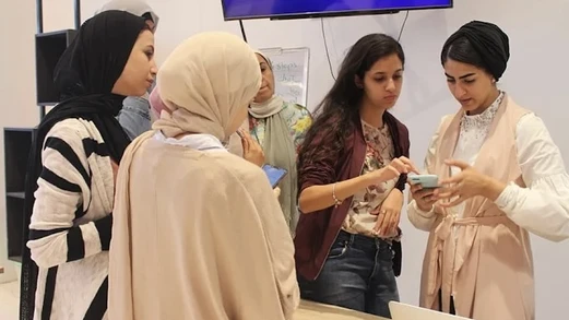 A group of women look at a product