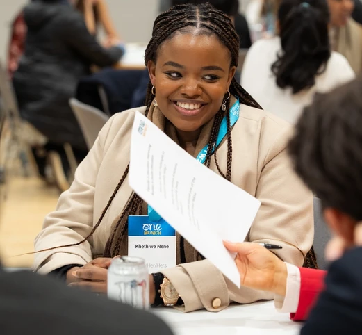 Delegate woman at the summit, sitting and smiling