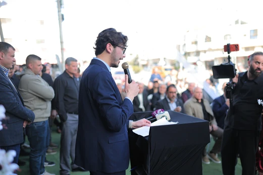 Dr. Momen AbuSaada speaks to a large crowd