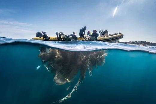 A net is cast under a boat