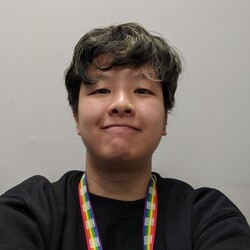 Portrait of Jia Wei Lee wearing black tee shirt and rainbow lanyard