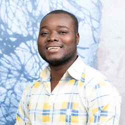 Portrait of Abdoul Ouahabo Kevin Dipama in checkered shirt
