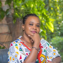 Portrait of Aminata Ly in shape patterned shirt against tropical background