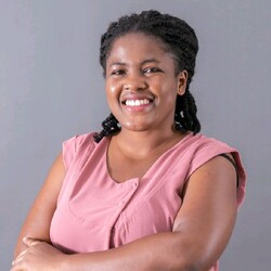 Portrait of Bintou Cisse in pink top against grey background