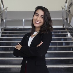 Portrait of Fernanda Ribeiro in smart dress with stairs in background