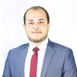 Mohammad Al-Othman portrait in navy blue suit and red spotted tie