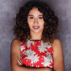 Portrait of Sabrina Nassih in floral red and white top