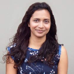 Portrait of Nandini Tanya Lallmon on blue floral dress